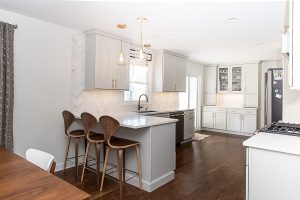 Kitchen with white cabinets, countertops, and backsplash