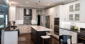 Updated kitchen with white countertops and cabinets. Spacious center island has black cabinets