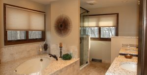 Updated master bathroom with jetted bathtub, double sink, and walk-in shower