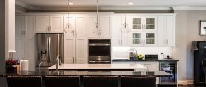 Updated kitchen with white cabinets, dark countertops, and stainless steel appliances