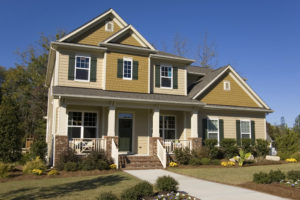 Two-story home with two-tone beige and mustard siding