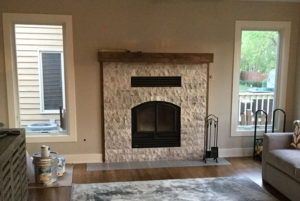 Cozy stone fireplace with windows on either side