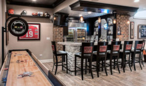 Gorgeous basement remodel with a bar and game room